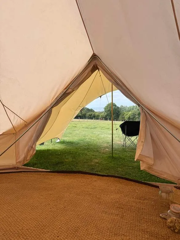 The view across the field framed in a tent doorway