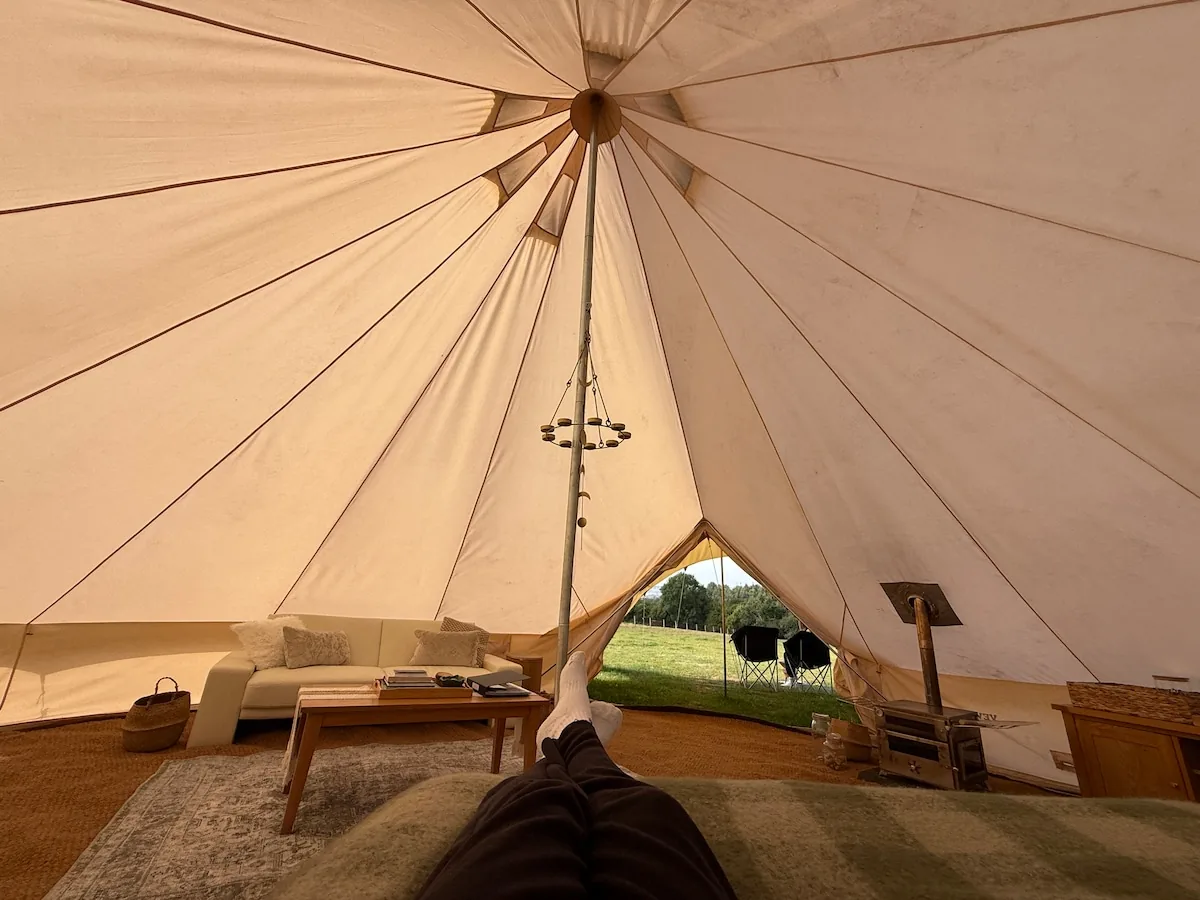 The Family Tent interior looking out through the open doorway to the field